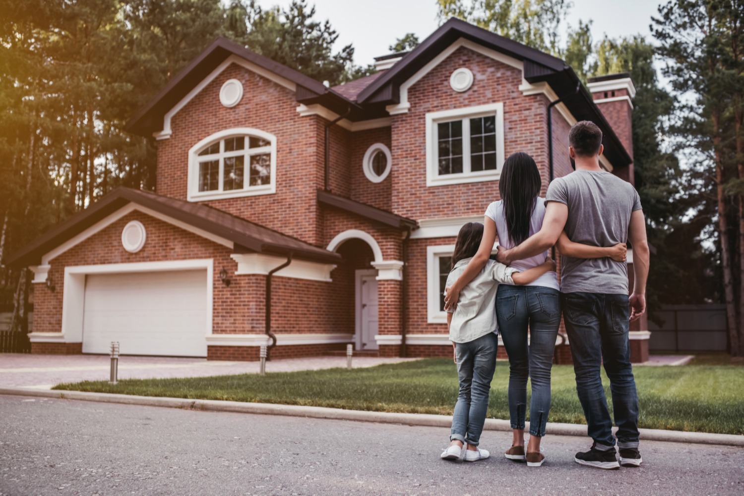 Couple standing in front of their new home
